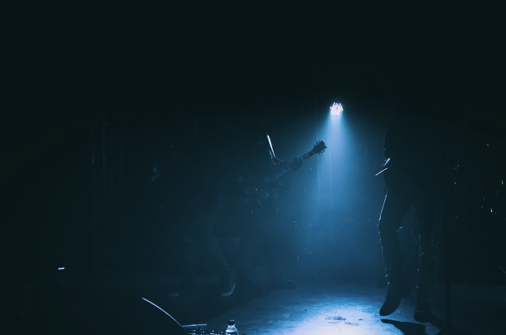 silhouette of man standing on stage