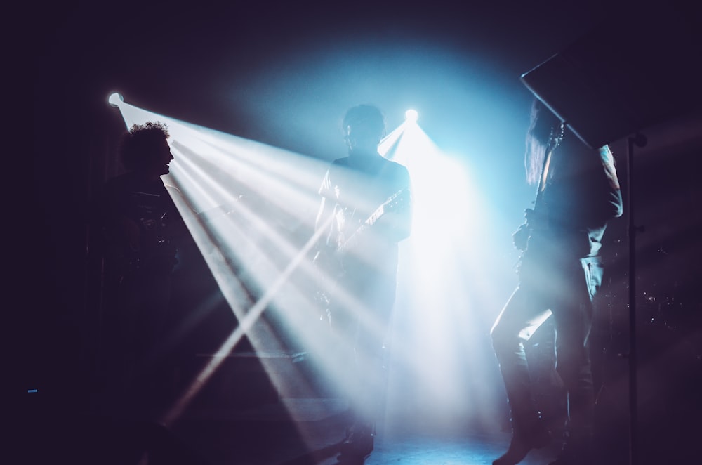 man in black shirt standing on stage