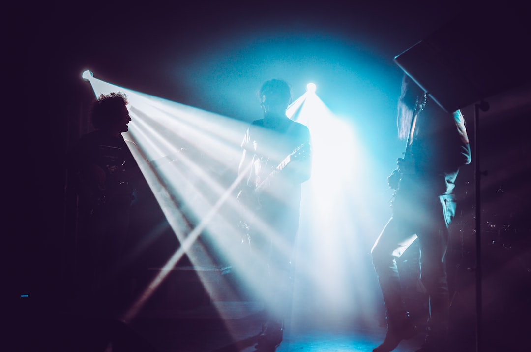 man in black shirt standing on stage