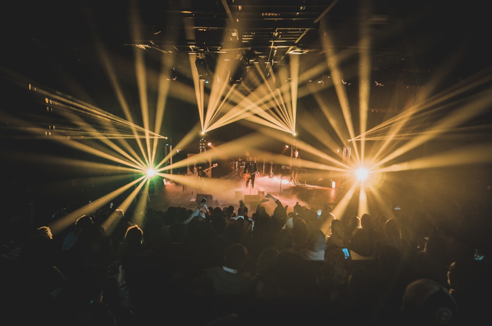 people standing on stage during night time