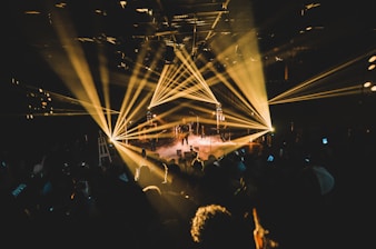 people standing on stage with lights