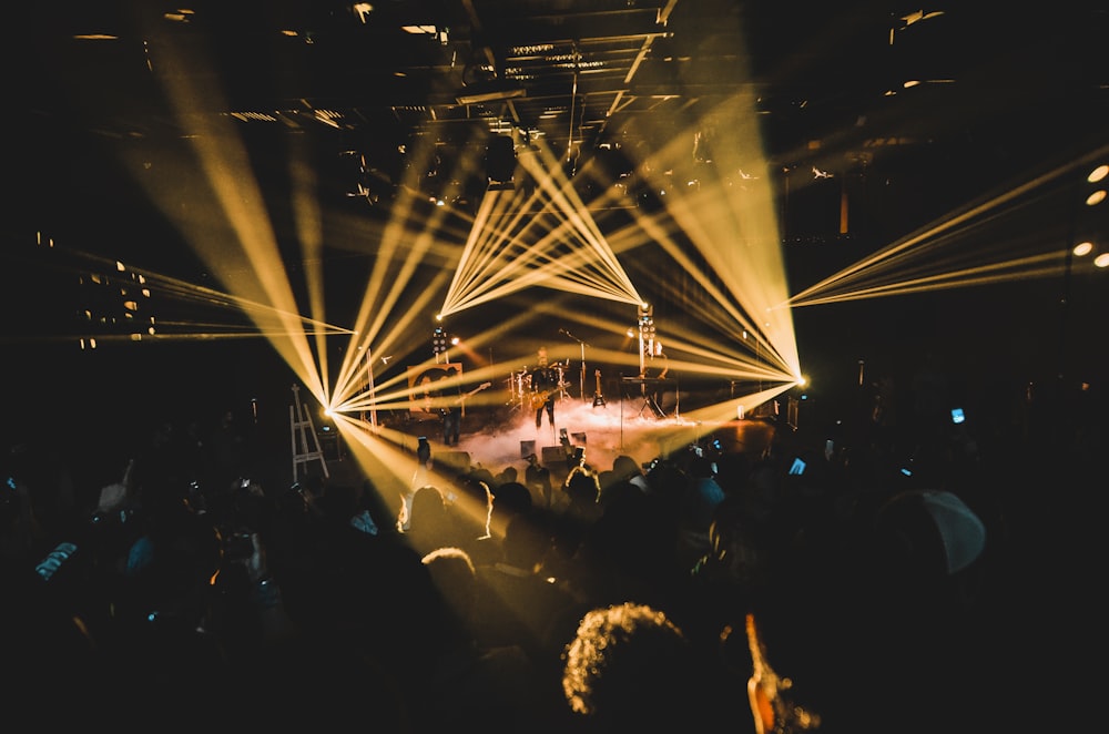 people standing on stage with lights