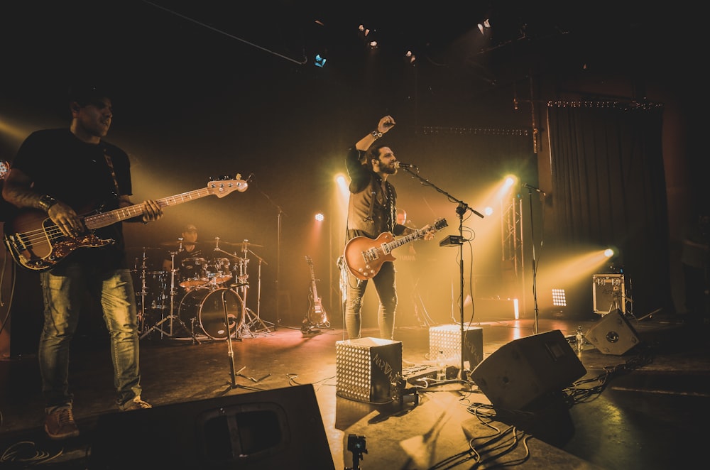 man playing guitar on stage