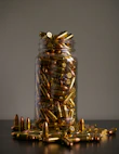 gold and silver coins in clear glass jar