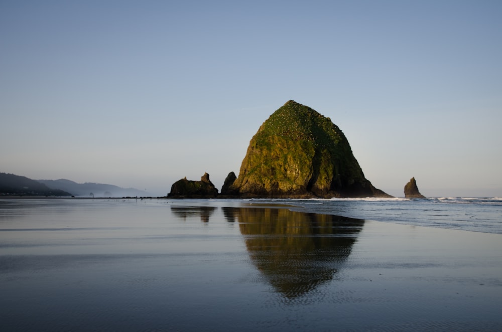 brown rock formation on sea water during daytime