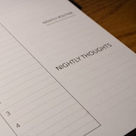 A close-up view of a planner page designed for nightly reflections. The page features sections titled 'Nightly Routine' and 'Nightly Thoughts', with checkboxes and lines for writing.