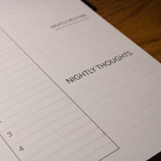 A close-up view of a planner page designed for nightly reflections. The page features sections titled 'Nightly Routine' and 'Nightly Thoughts', with checkboxes and lines for writing.