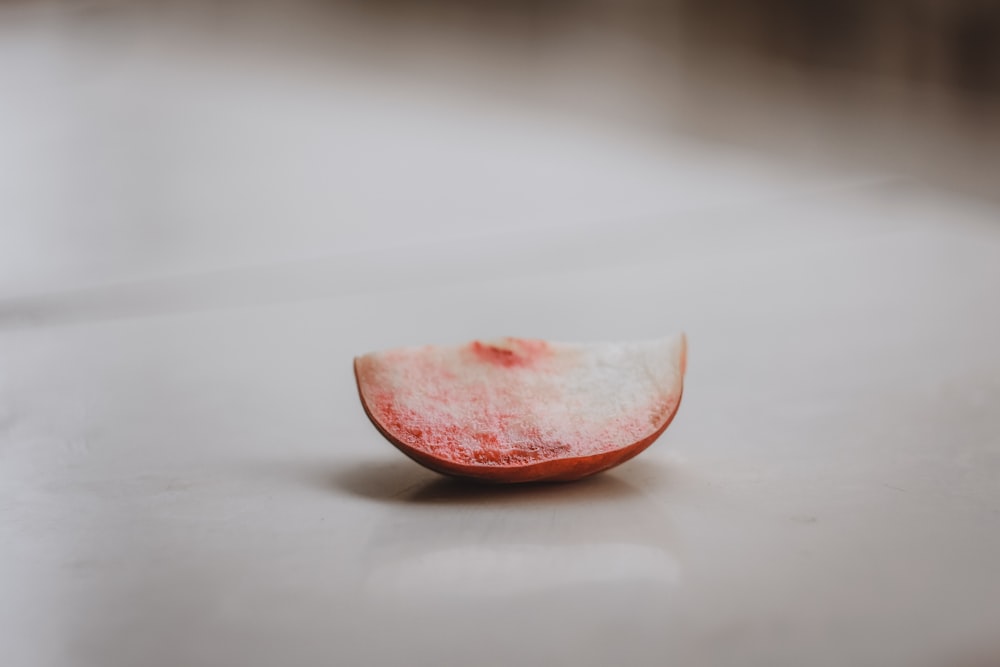 sliced tomato on white table