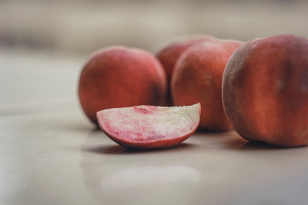 two red round fruits on white textile