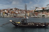 Traditional wooden boats gliding on the calm Douro waters.