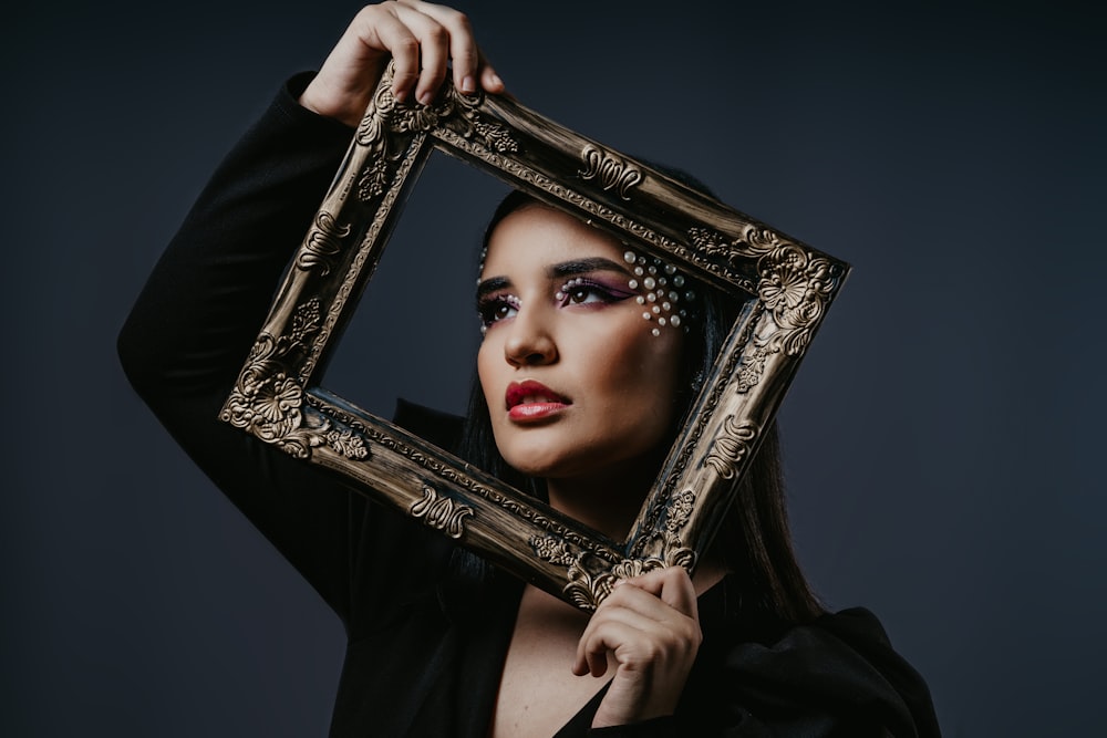 woman in black shirt holding black photo frame