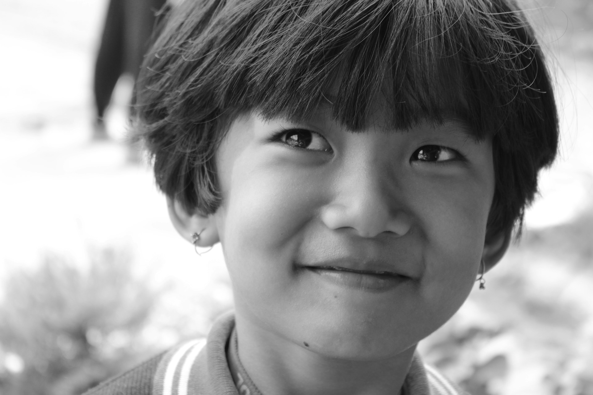 grayscale photo of boy in crew neck shirt