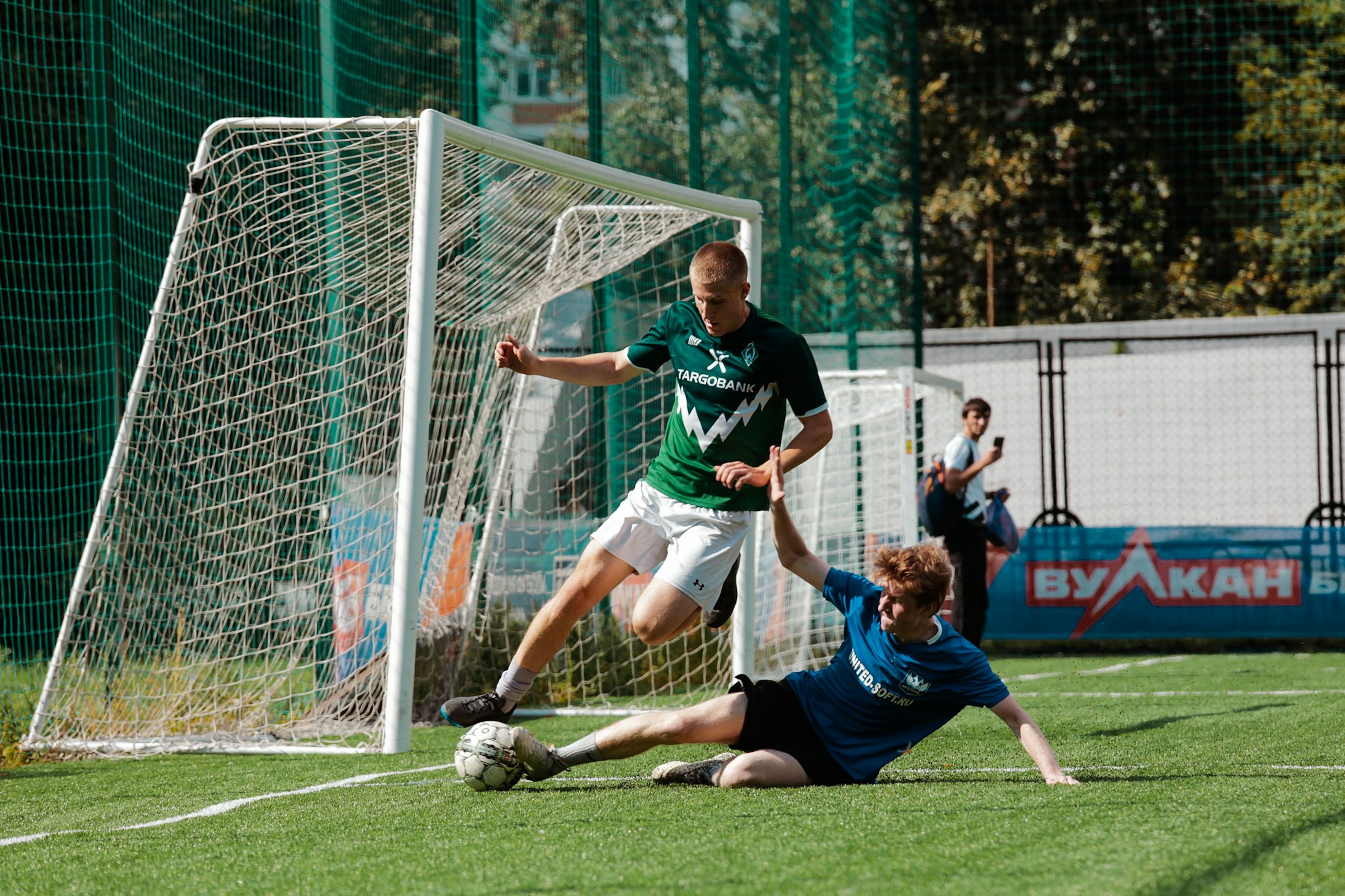 Player slide tackling another football player