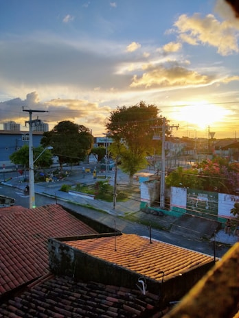 Sunset over the terracotta rooftops of Marrakech medina with vibrant saffron sky.