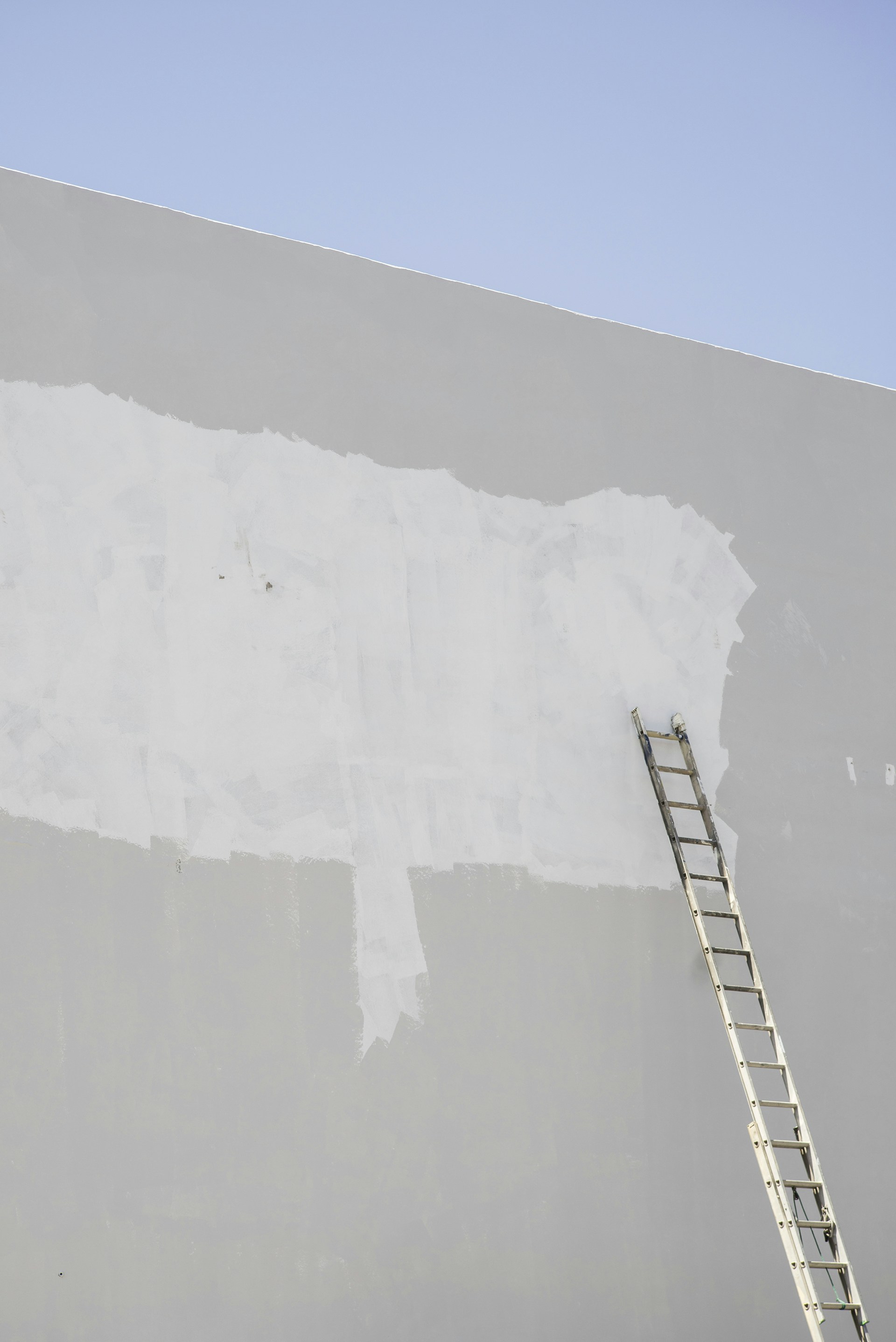 white metal ladder on white snow covered ground