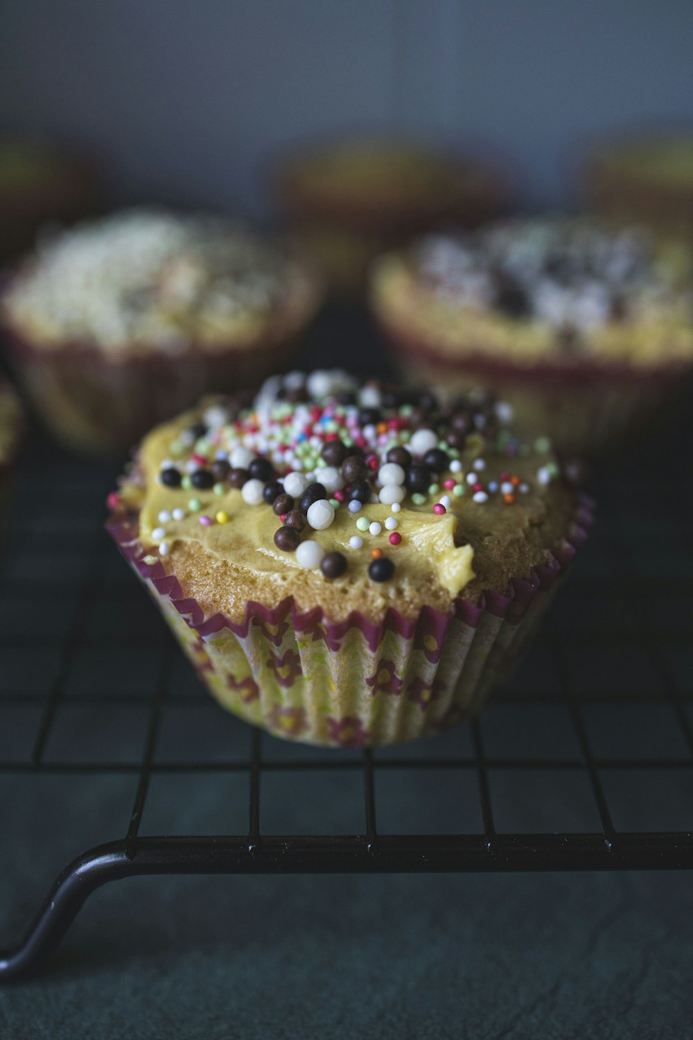 brown and white cupcake with sprinkles on top