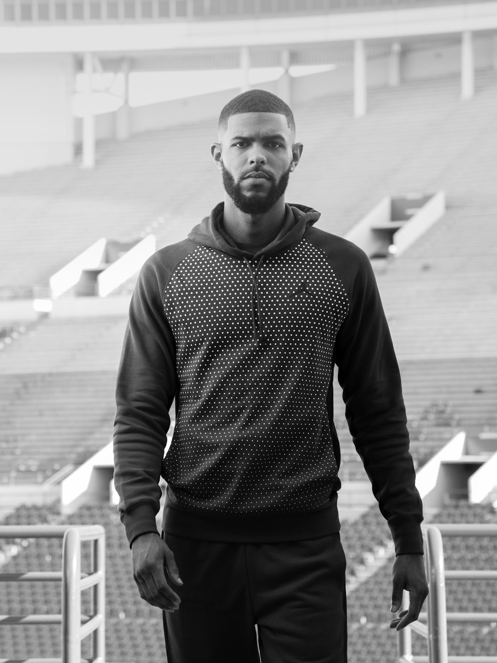 man in black and white sweater standing on the street