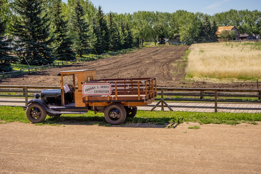 brown utility trailer on dirt road during daytime