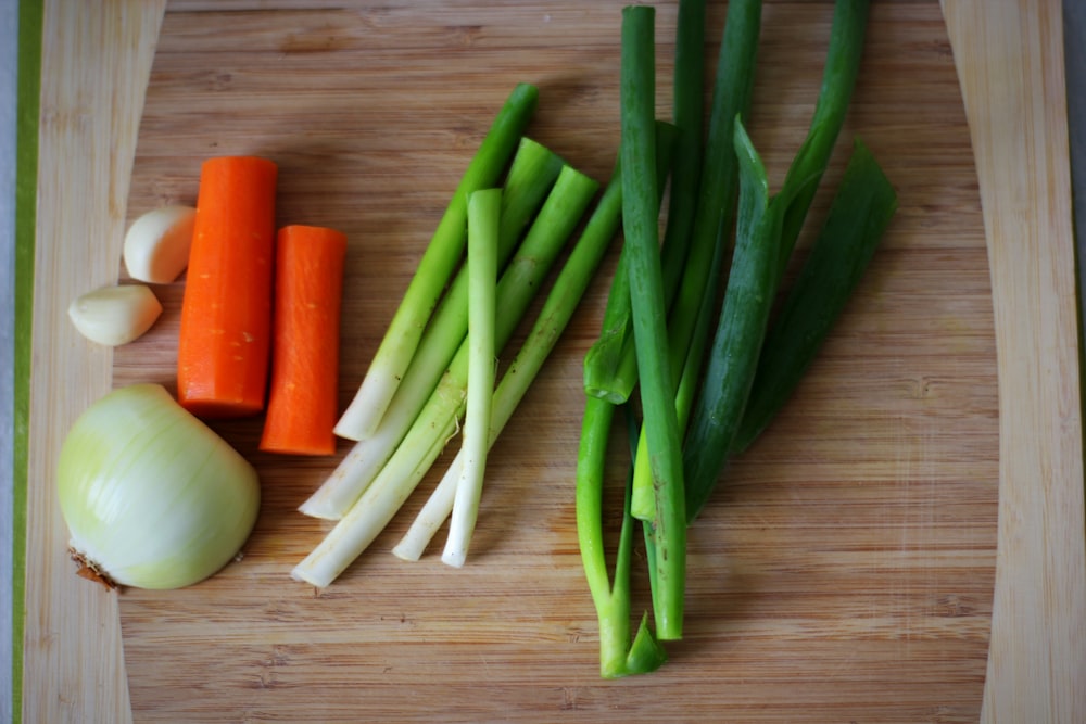 green chili pepper and orange carrot on brown wooden table