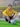 boy in yellow sweater and black pants sitting on soccer goal net