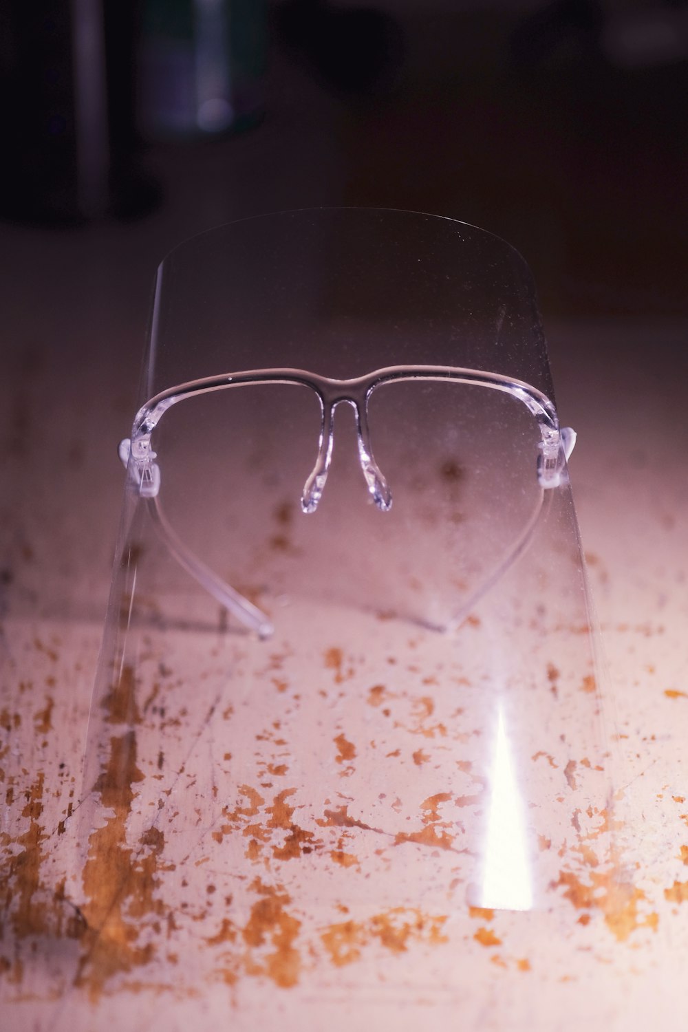 silver framed eyeglasses on white textile