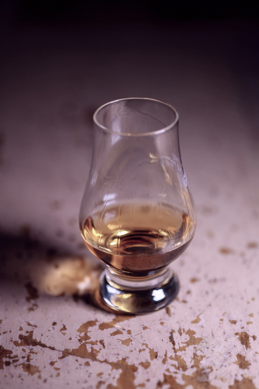 clear drinking glass with brown liquid