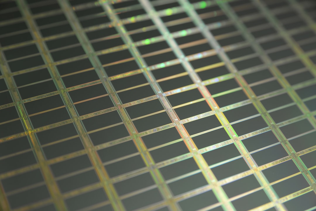 yellow and black checked pattern, This is a macro of a silicon wafer. Each square is a chip with microscopic transistors and circuits. Ordinarily, wafers like these are diced into their individual chips and the chips go into the processors that power our computers. Sometimes, wafers have flaws and the manufacturers dispose of them instead. That’s how I got mine. After visiting the tech museums in Silicon Valley, I was amazed at the beauty of silicon wafers, so I started collecting and photographing them. Like fractals and flowers, the closer you get to them, the more amazing details there are to see.