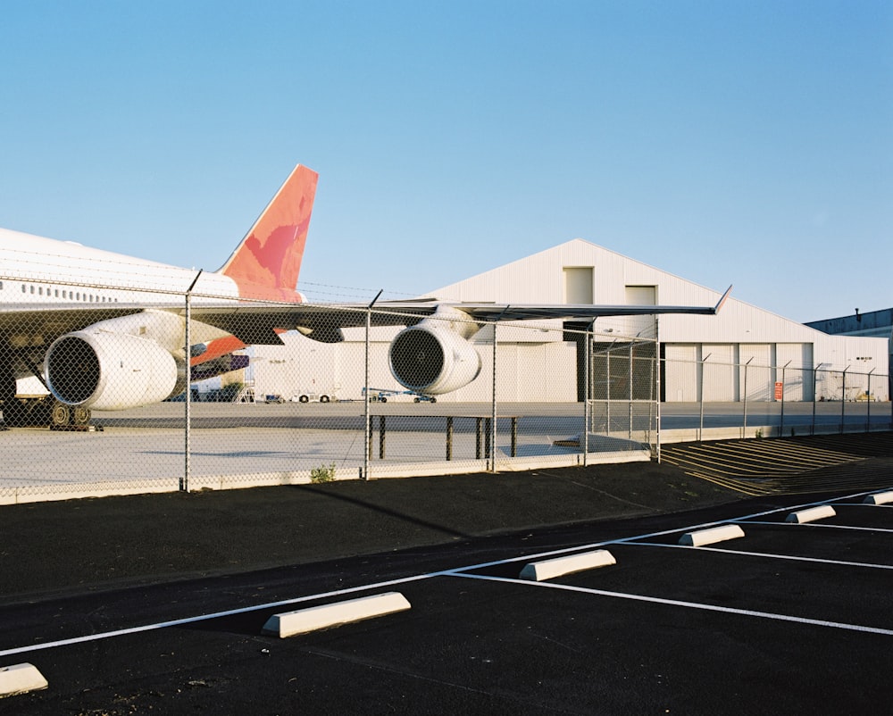 white and red airplane on airport during daytime