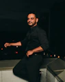 man in black dress shirt and black pants