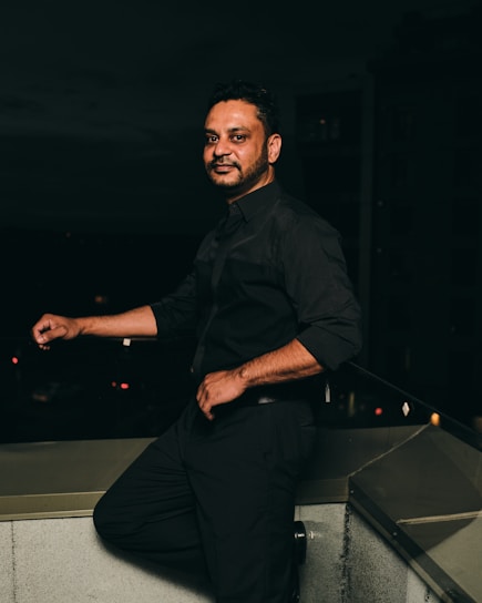 man in black dress shirt and black pants