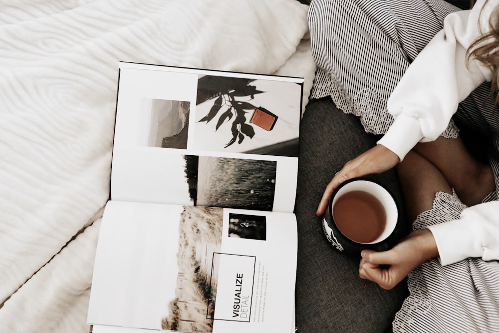 person holding white ceramic mug