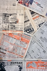 a pile of newspapers sitting on top of each other