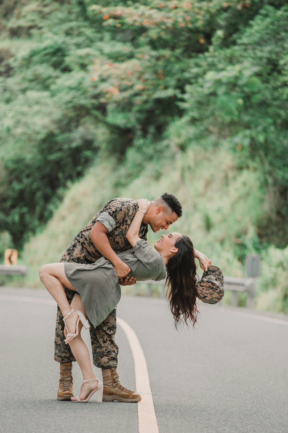 man and woman kissing on road during daytime