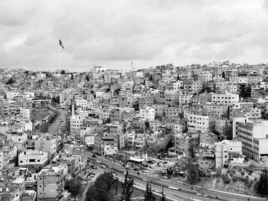 grayscale photo of city buildings during daytime in Amman Citadel Jordan