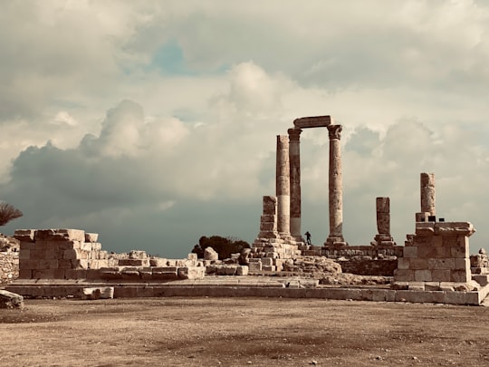 brown concrete building under white clouds during daytime in Amman Citadel Jordan