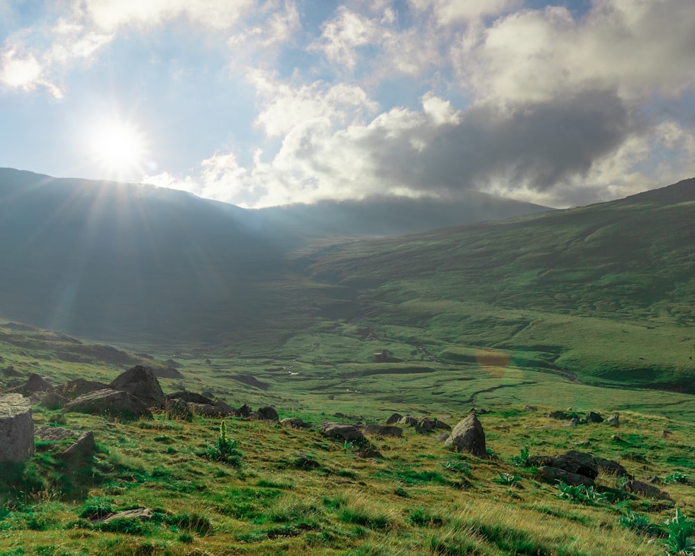 green grass field and mountain during daytime