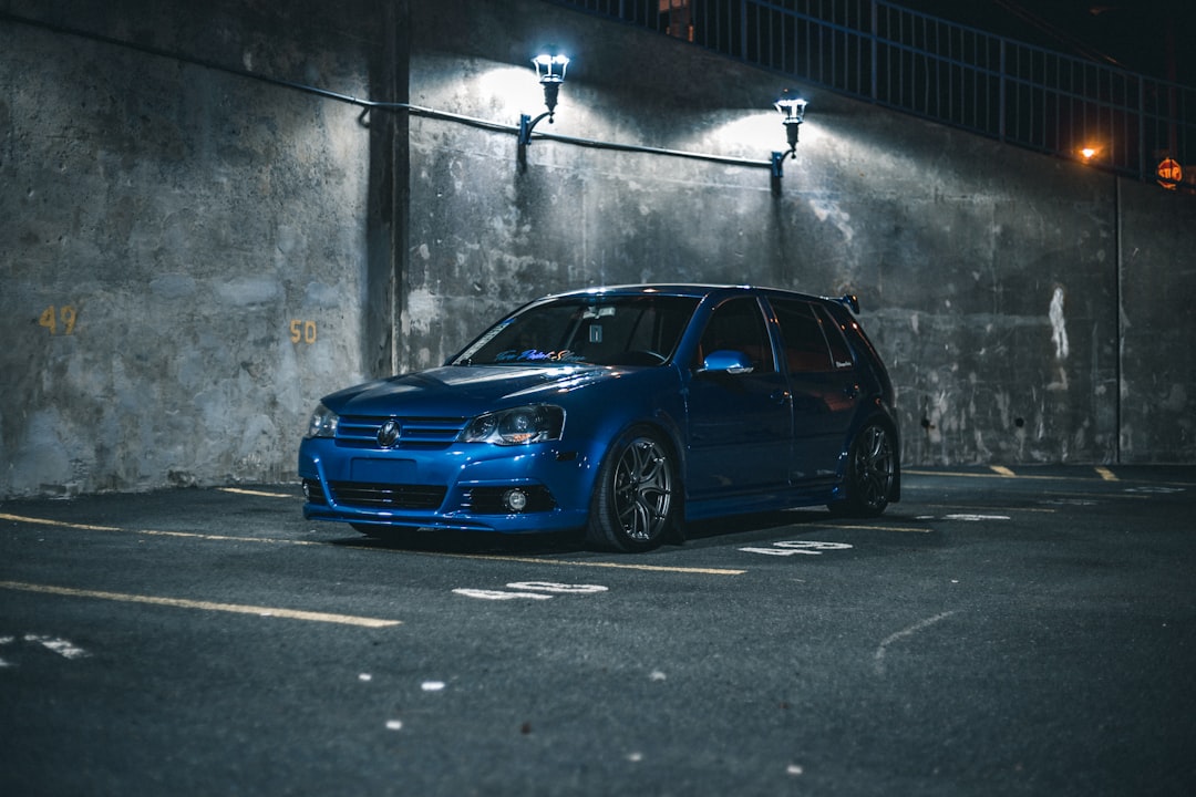 blue sedan on gray asphalt road during daytime