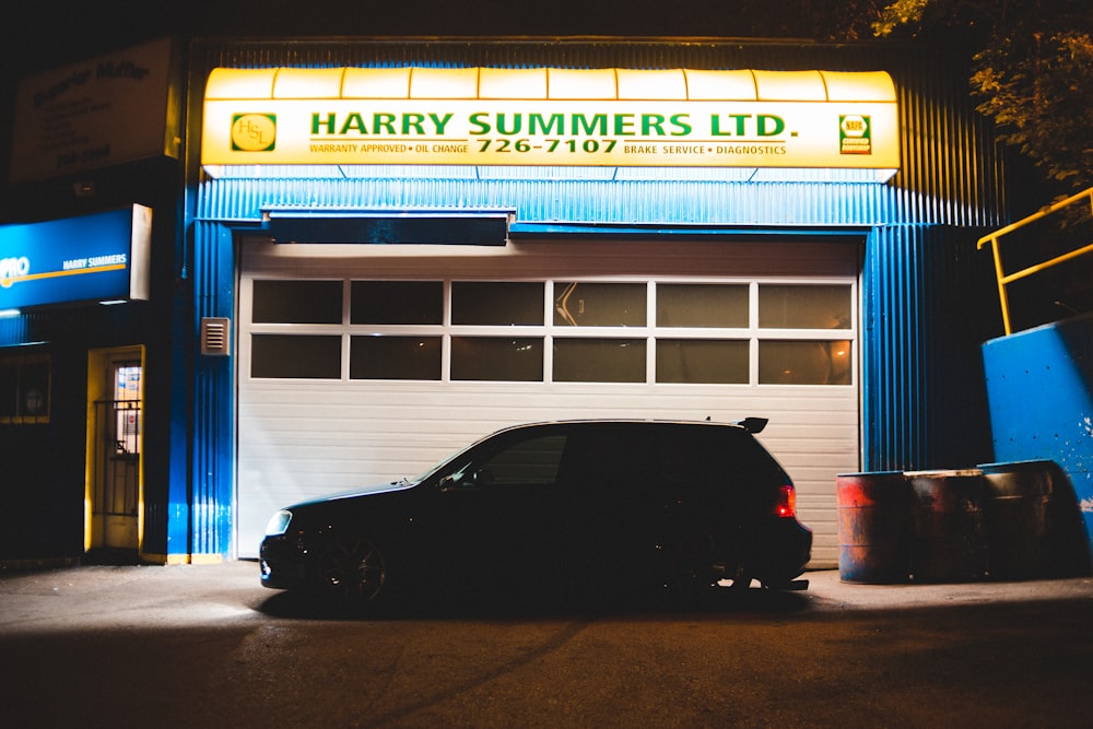 black car parked in front of store