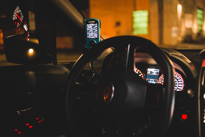 black steering wheel in close up photography