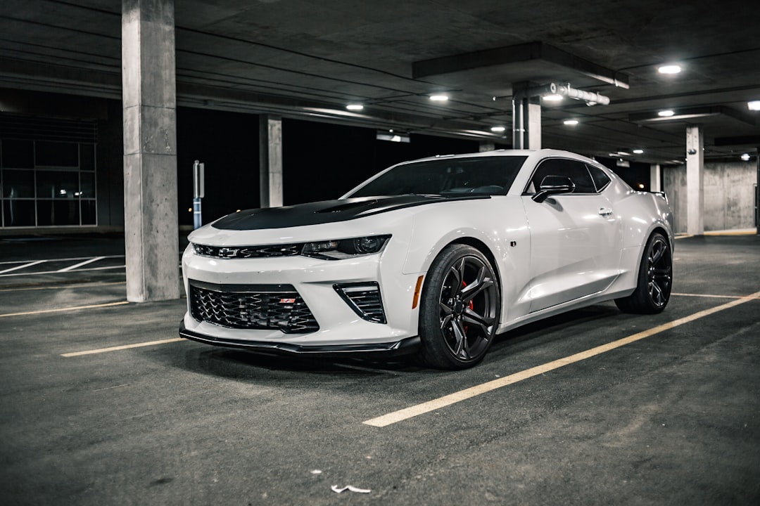 white chevrolet camaro parked on parking lot