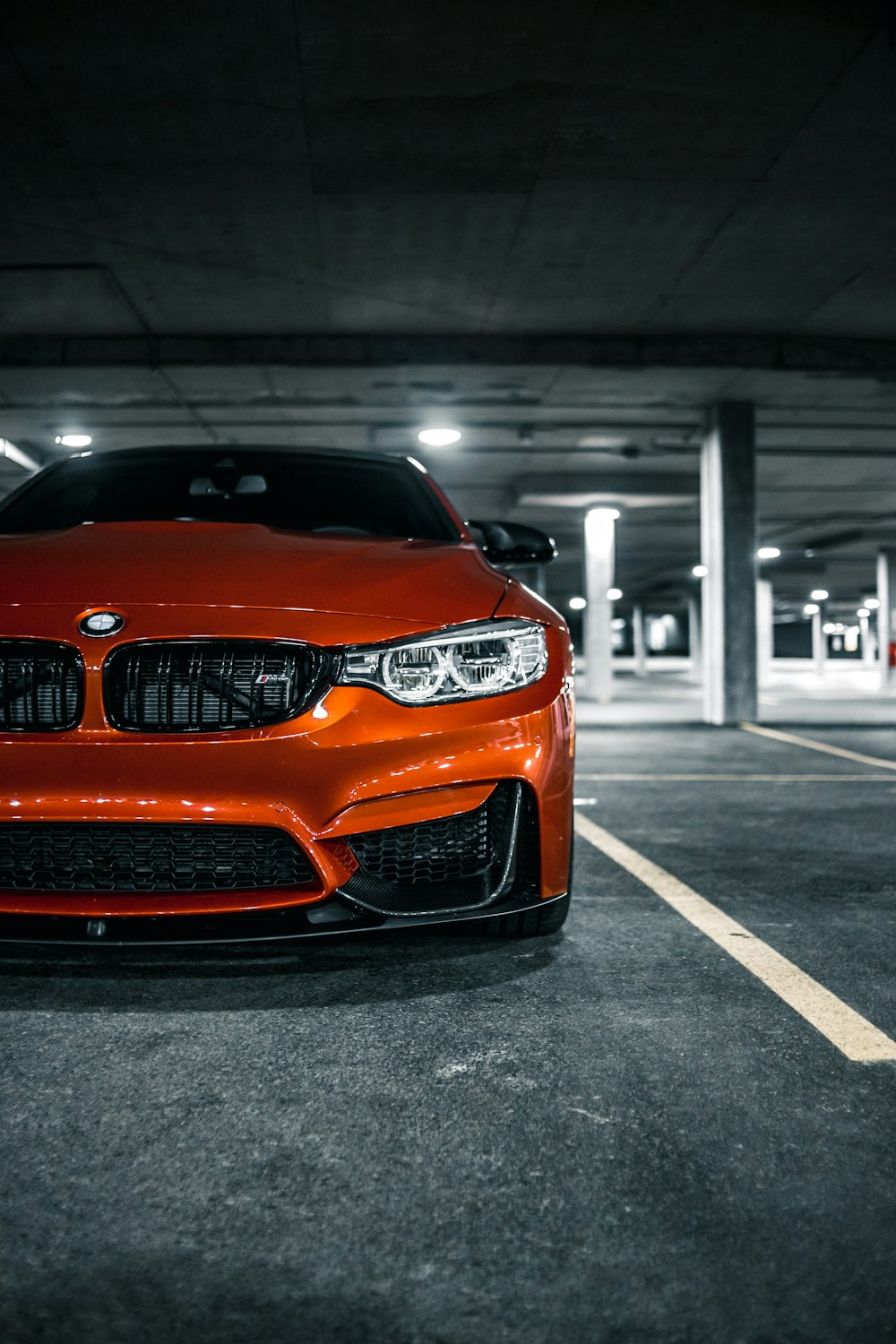 orange bmw m 3 parked on parking lot