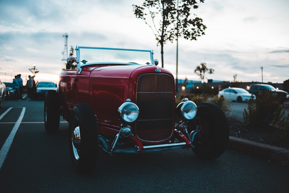 red and white vintage car on road during daytime