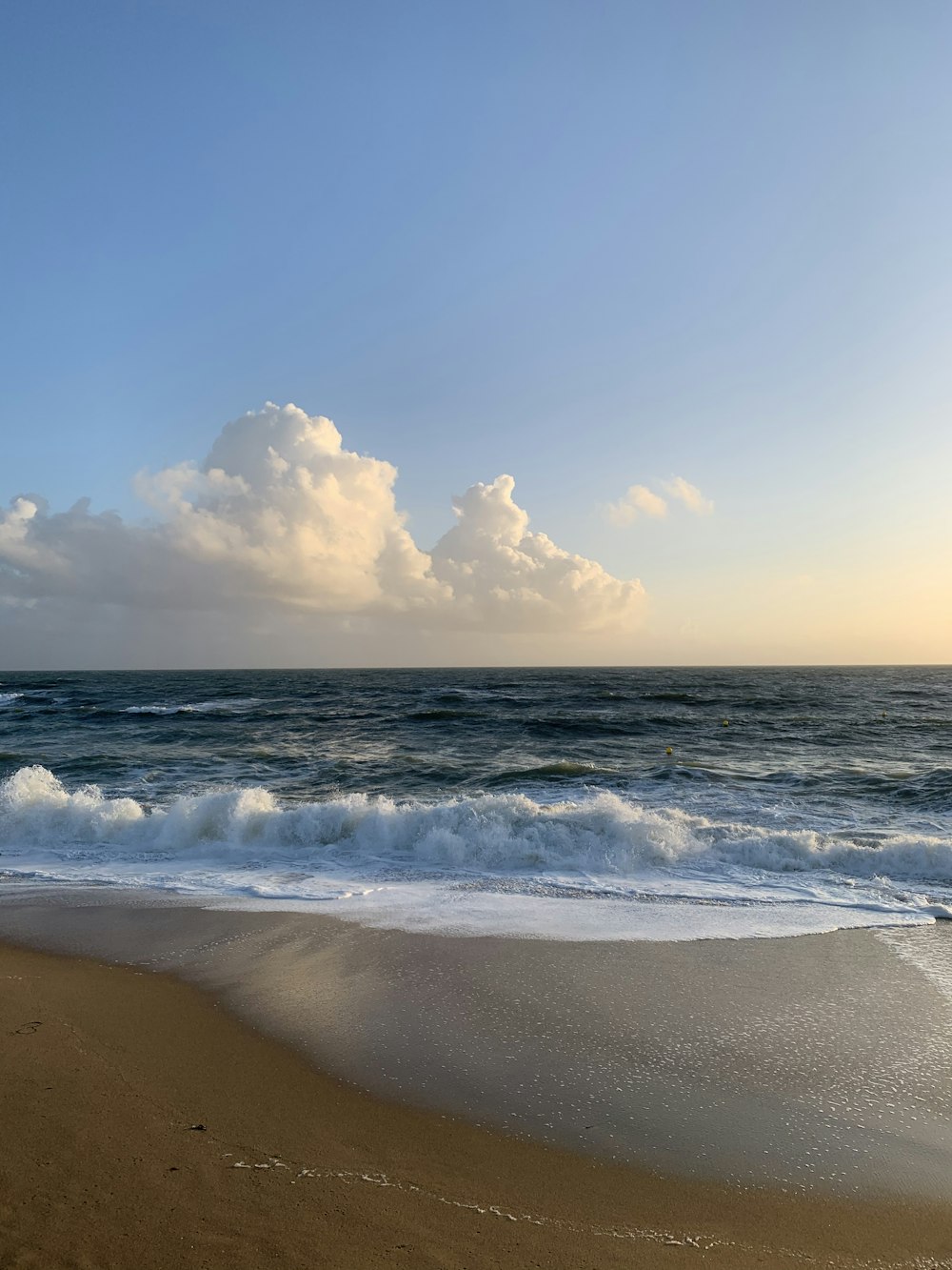 ocean waves crashing on shore during daytime