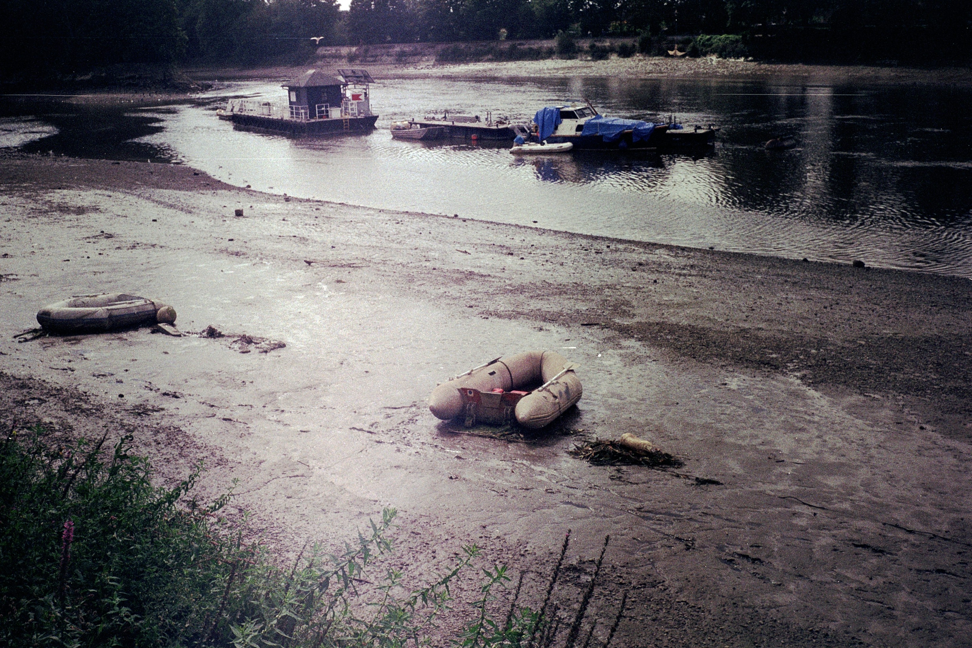 woman in brown leather boots lying on white sand near body of water during daytime