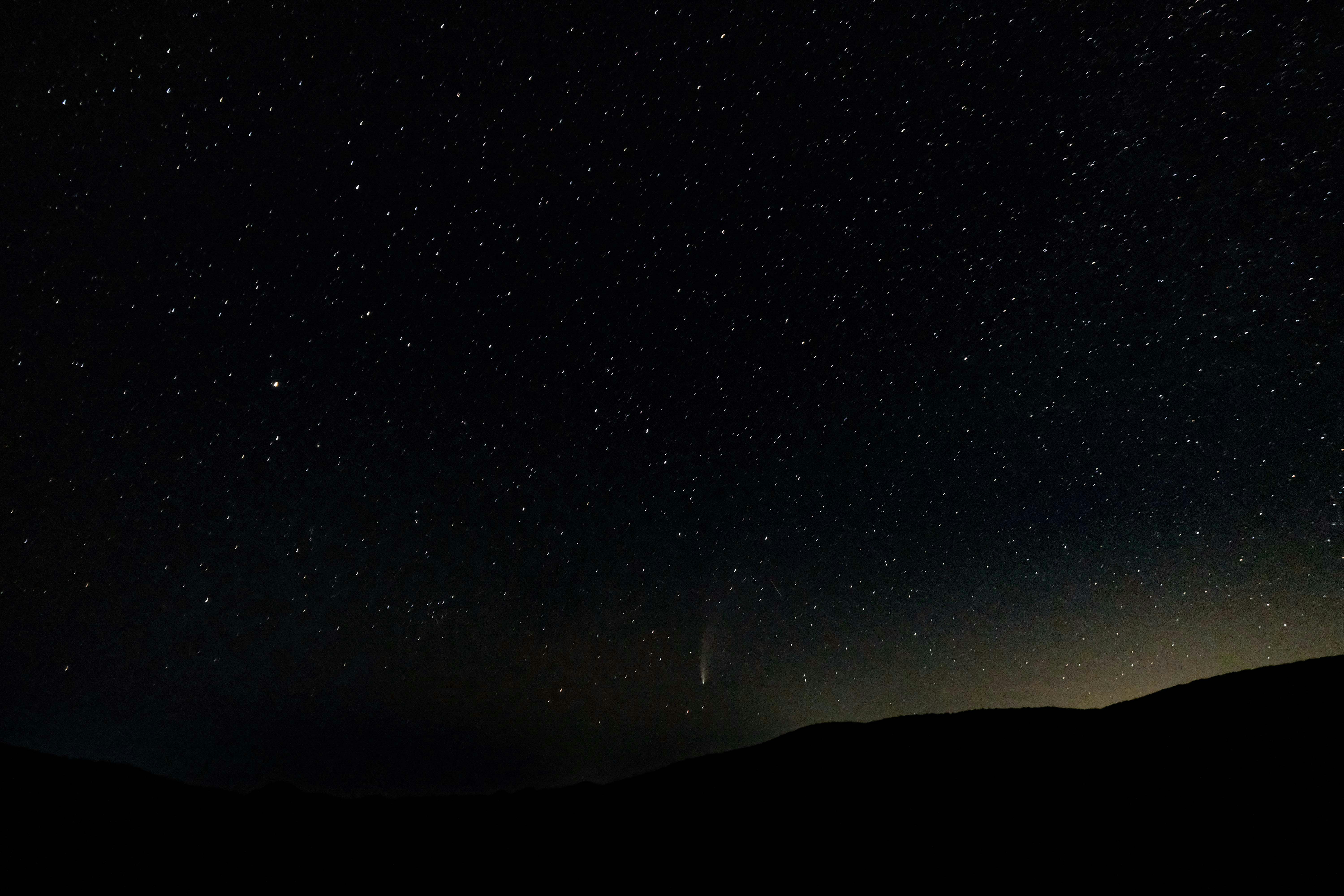 silhouette of mountain under starry night