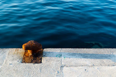 A rugged Magnum exothermic cutter resting on a weathered dock by the sea.
