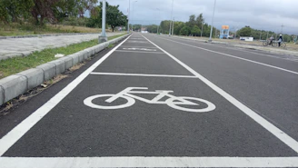 A freshly paved road in Dammam with clear lane markings under a bright sky.
