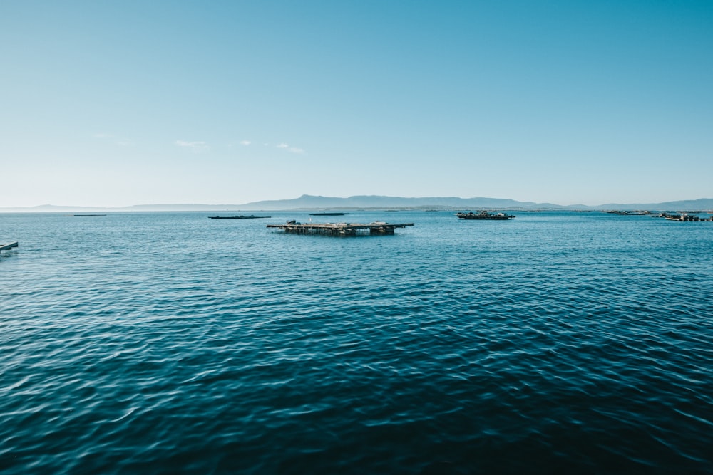 white boat on sea under blue sky during daytime