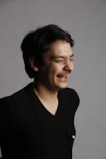 smiling woman in black v neck shirt