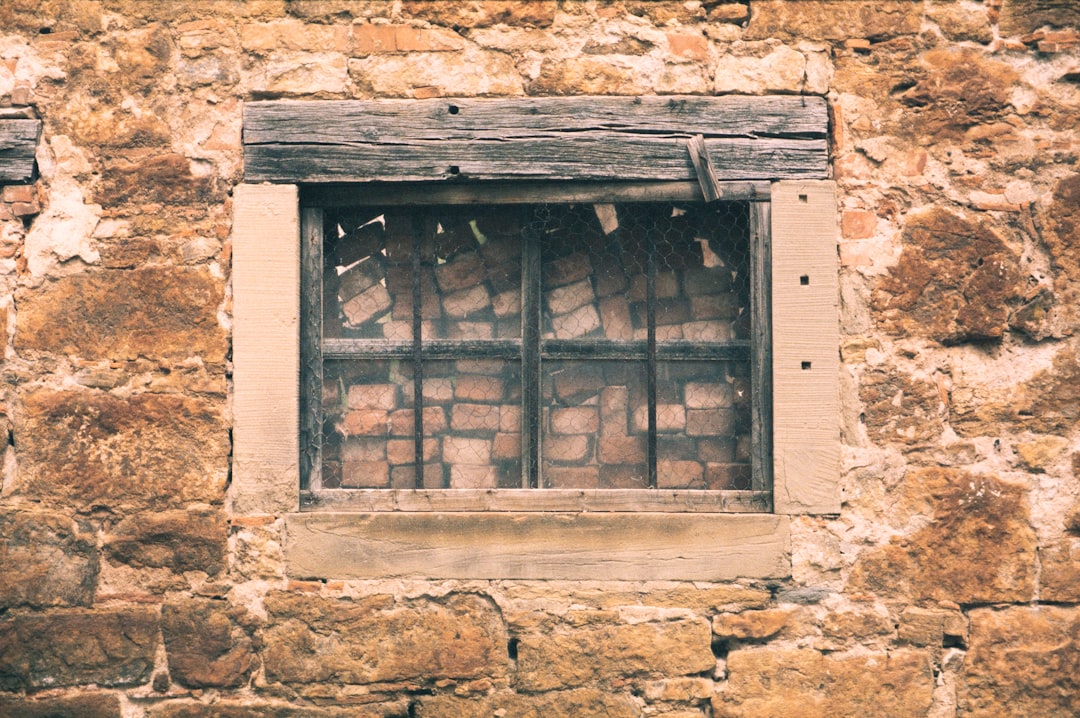 brown wooden window on brown concrete wall